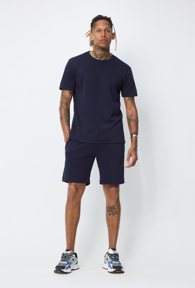 Ensemble basic bleu marine de la marque NO LIMIT, comprenant un haut et un pantalon en tissu doux, porté par un mannequin.