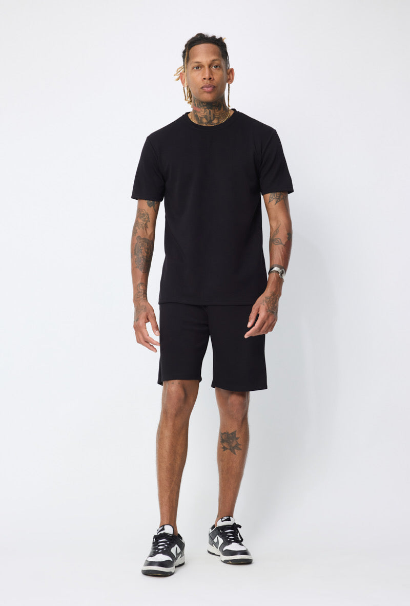 Ensemble basic noir de la marque NO LIMIT, vêtement simple et élégante avec haut et pantalon assortis.